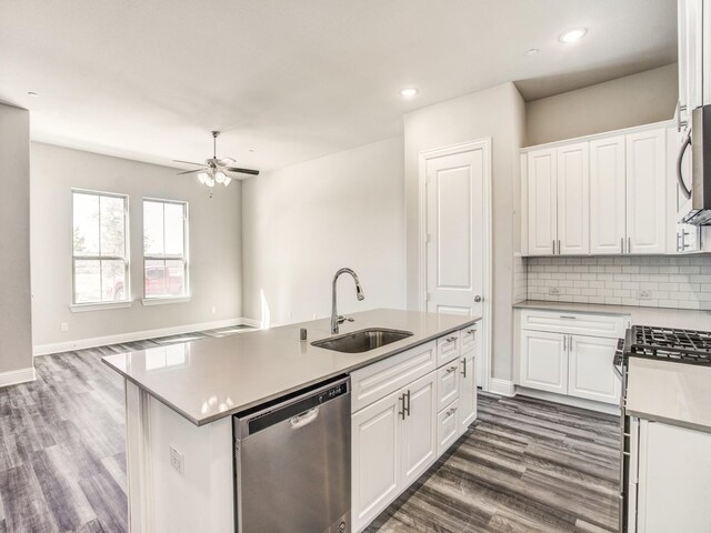 kitchen featuring white cabinetry, sink, dark wood-type flooring, a kitchen island with sink, and appliances with stainless steel finishes