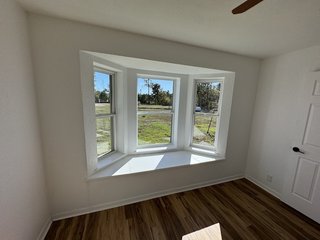 unfurnished room with ceiling fan and dark hardwood / wood-style floors