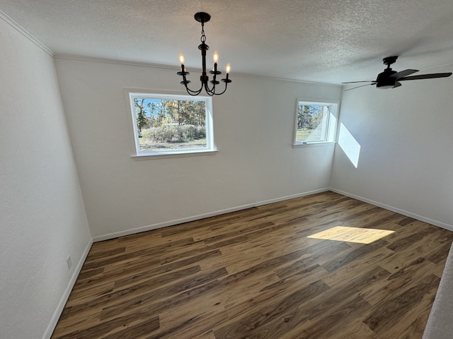 unfurnished dining area with dark hardwood / wood-style floors, ceiling fan with notable chandelier, and a textured ceiling