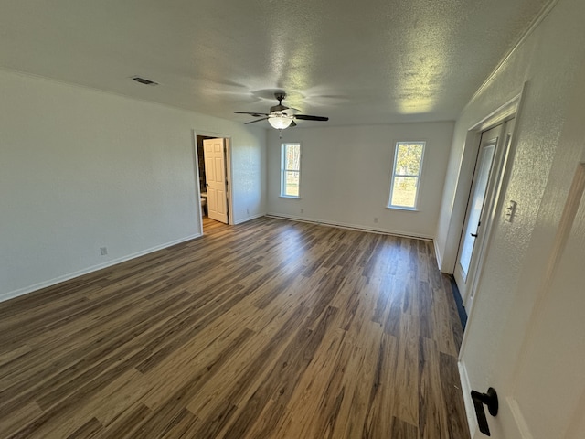 unfurnished room with a textured ceiling, ceiling fan, and dark hardwood / wood-style floors