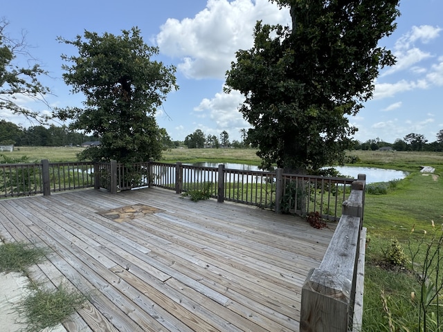 wooden terrace featuring a water view