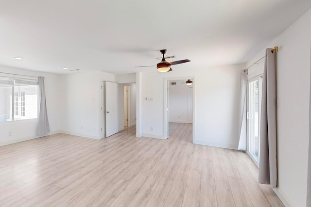 empty room featuring ceiling fan and light hardwood / wood-style floors