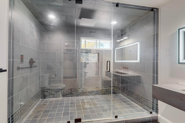 bathroom with vanity, a shower with shower door, and toilet