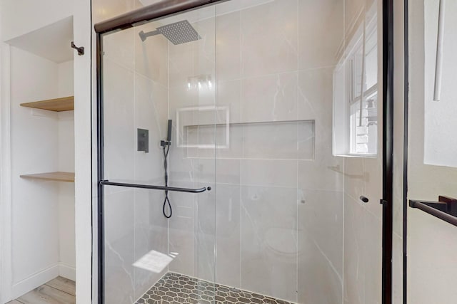 bathroom featuring hardwood / wood-style floors and walk in shower