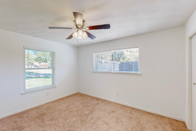 unfurnished room featuring light carpet and ceiling fan