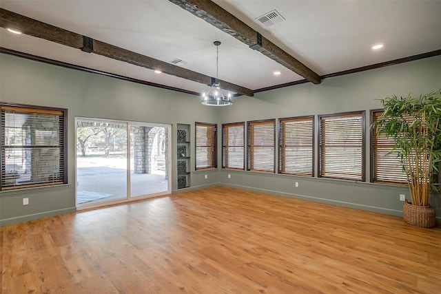 empty room featuring beam ceiling, an inviting chandelier, ornamental molding, and light hardwood / wood-style flooring