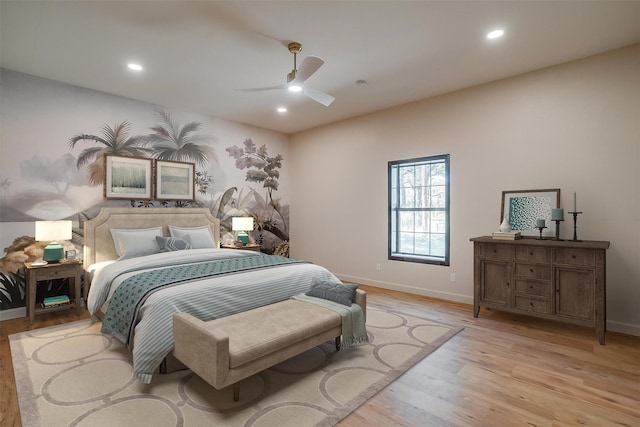 bedroom with light hardwood / wood-style flooring and ceiling fan