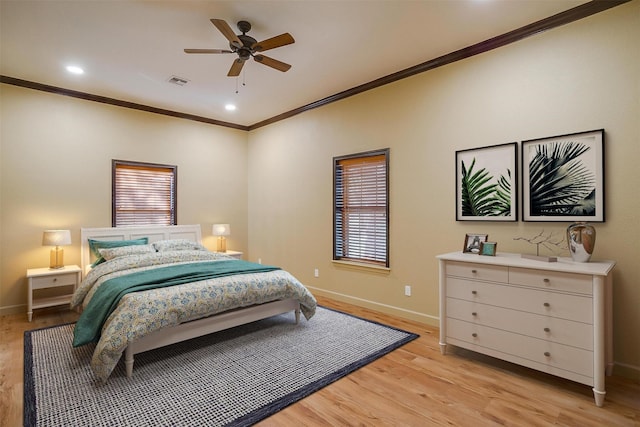 bedroom with multiple windows, ceiling fan, crown molding, and light wood-type flooring