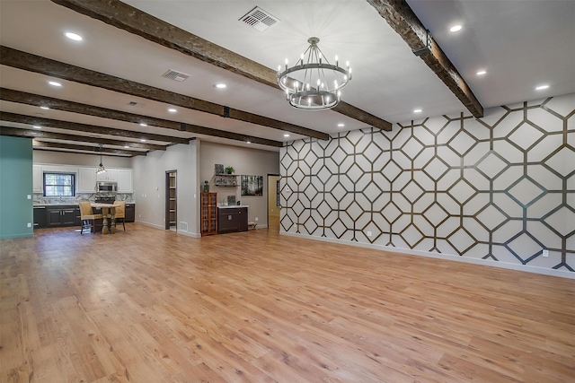 miscellaneous room with light hardwood / wood-style flooring, beamed ceiling, and a notable chandelier