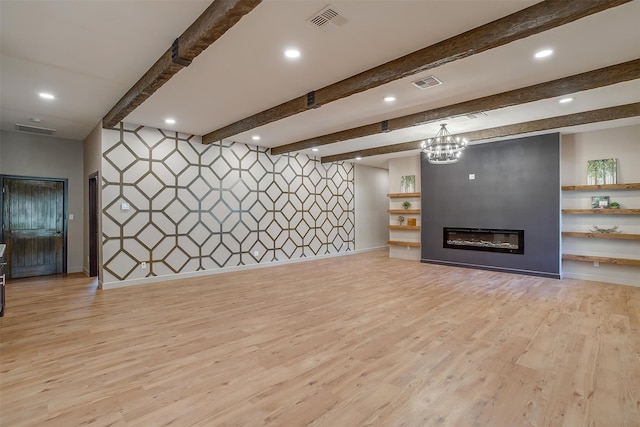 unfurnished living room featuring beam ceiling, an inviting chandelier, and light hardwood / wood-style flooring