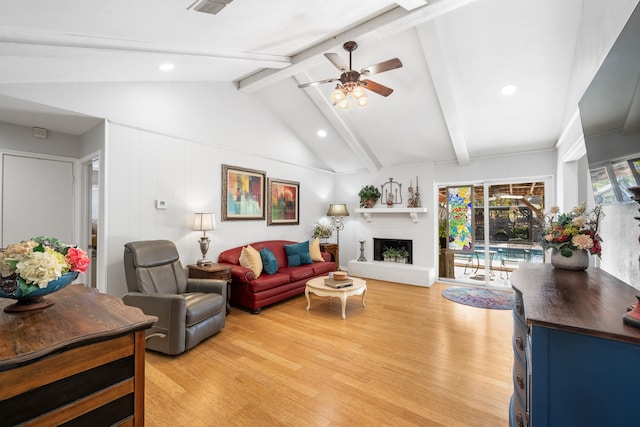 living room with a fireplace, vaulted ceiling with beams, light hardwood / wood-style floors, and ceiling fan