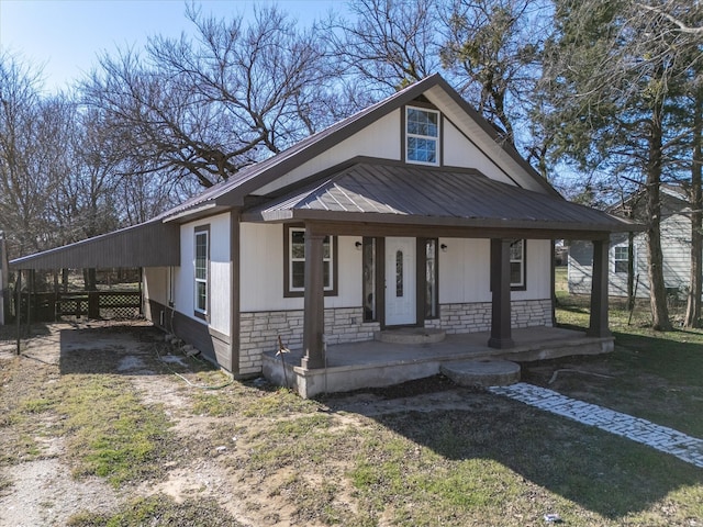 view of front of house featuring a porch and a carport