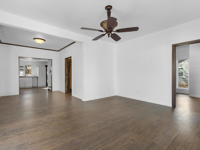 empty room with ceiling fan and dark wood-type flooring