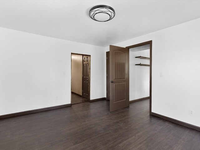 empty room with dark hardwood / wood-style floors