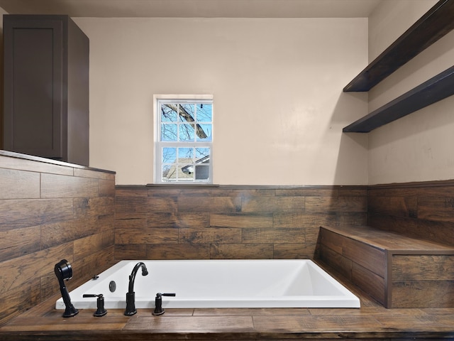 bathroom featuring tiled tub