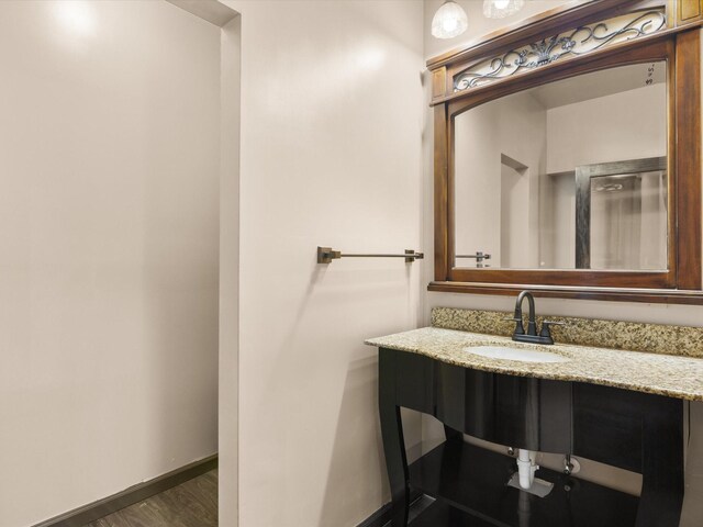 bathroom with hardwood / wood-style floors and vanity