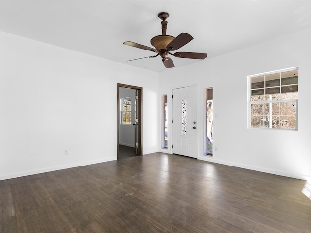 interior space with ceiling fan and dark wood-type flooring