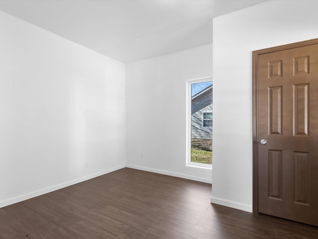 spare room featuring dark wood-type flooring