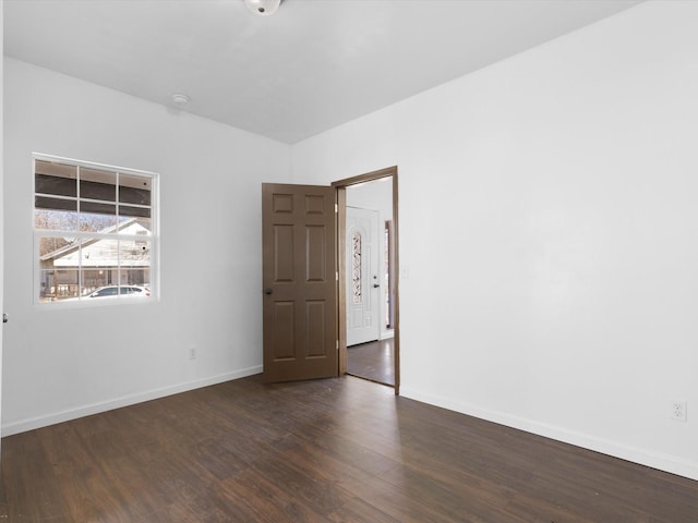 spare room featuring dark hardwood / wood-style flooring