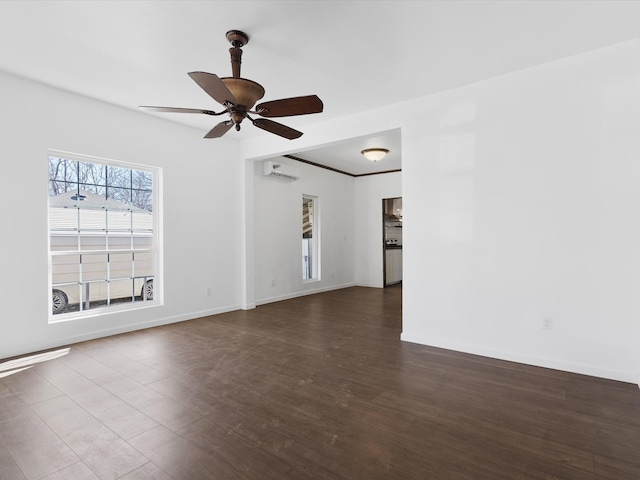 empty room featuring a wall unit AC, dark hardwood / wood-style floors, and ceiling fan