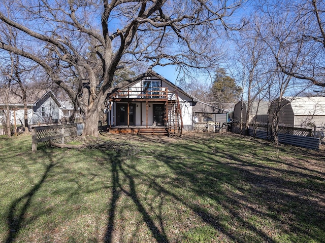 back of house with a lawn and a deck