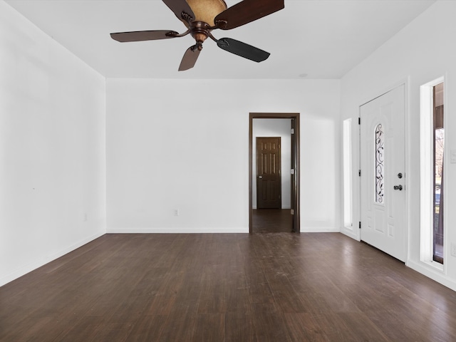 empty room featuring ceiling fan and dark hardwood / wood-style flooring