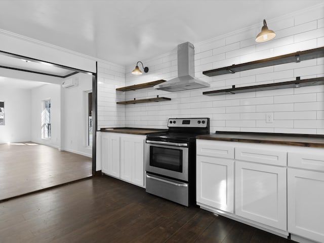 kitchen with wall chimney exhaust hood, white cabinetry, stainless steel electric range oven, ornamental molding, and dark hardwood / wood-style flooring