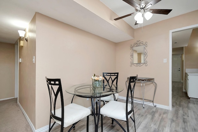 dining area with ceiling fan, light wood-style flooring, and baseboards