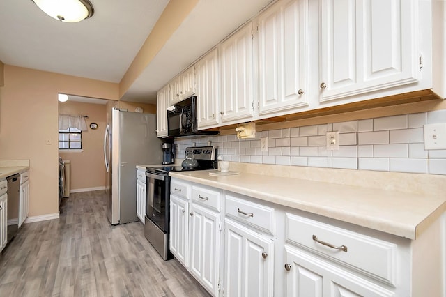 kitchen with appliances with stainless steel finishes, light countertops, decorative backsplash, and white cabinetry