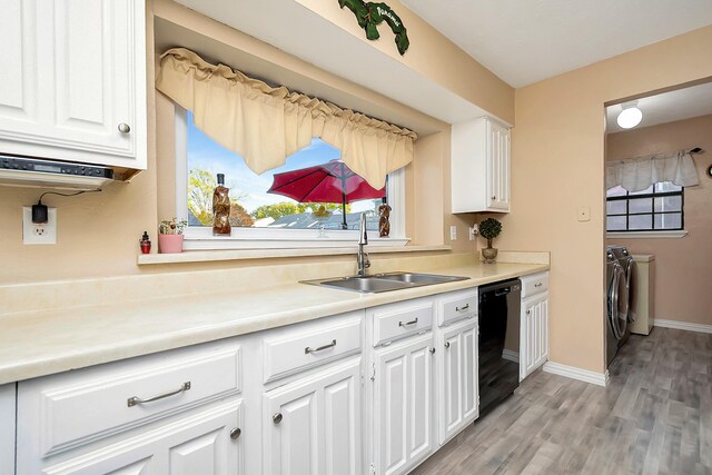 kitchen with washer and dryer, light countertops, dishwasher, and white cabinetry