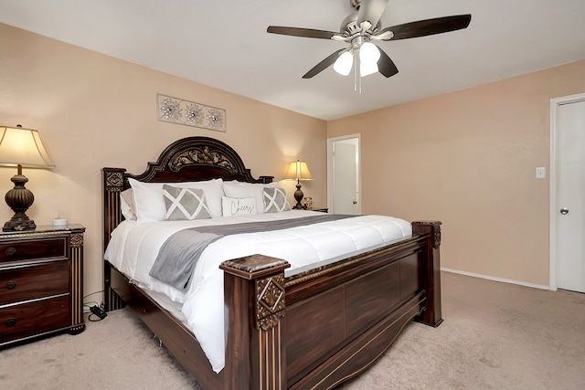 bedroom with light colored carpet, ceiling fan, and baseboards