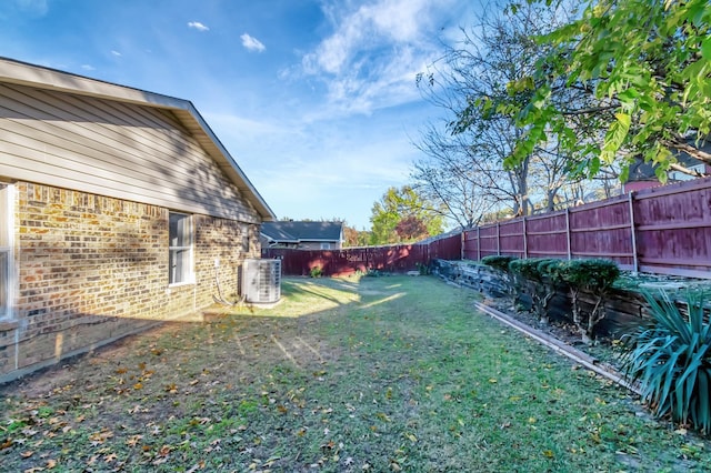 view of yard with central AC unit and a fenced backyard