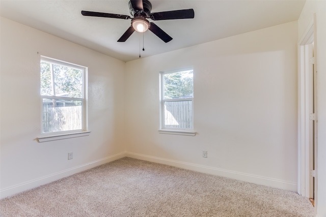 carpeted spare room with ceiling fan