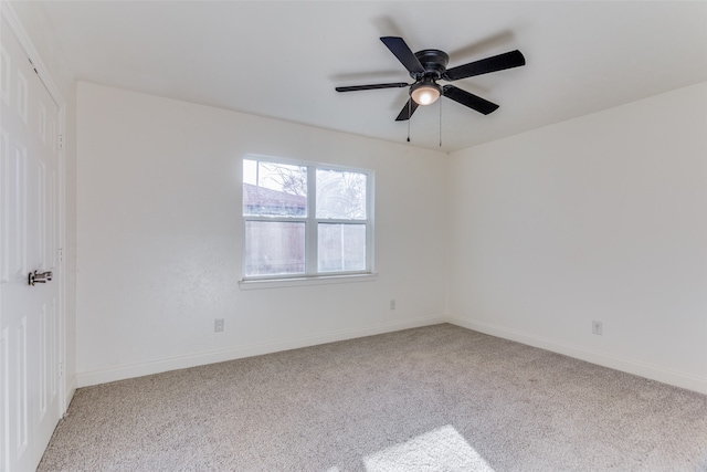 spare room with light colored carpet and ceiling fan