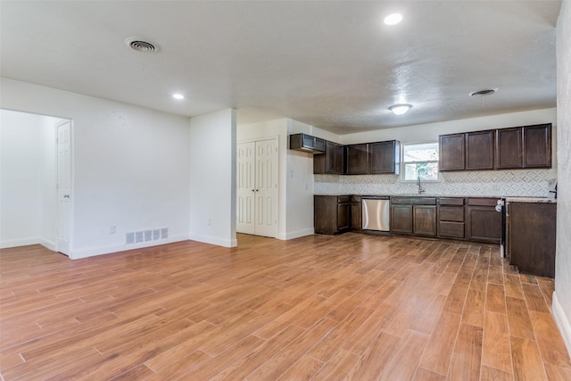 kitchen featuring tasteful backsplash, light hardwood / wood-style flooring, dark brown cabinetry, and dishwasher