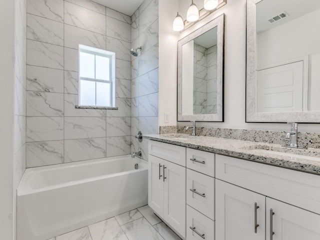 bathroom with vanity and tiled shower / bath combo