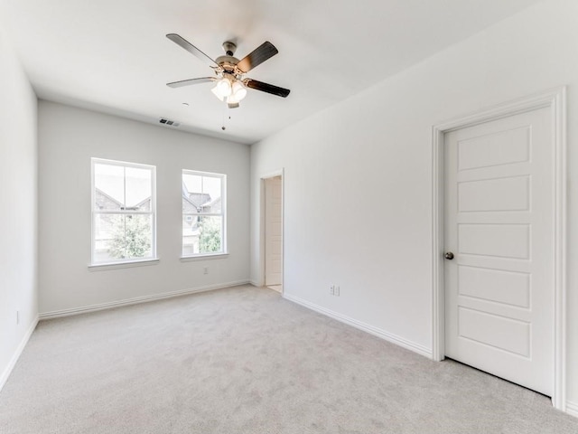 carpeted spare room with ceiling fan