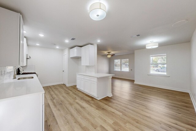 unfurnished room featuring ceiling fan and light hardwood / wood-style flooring