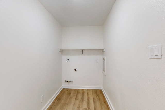 unfurnished living room featuring ceiling fan, sink, and light wood-type flooring