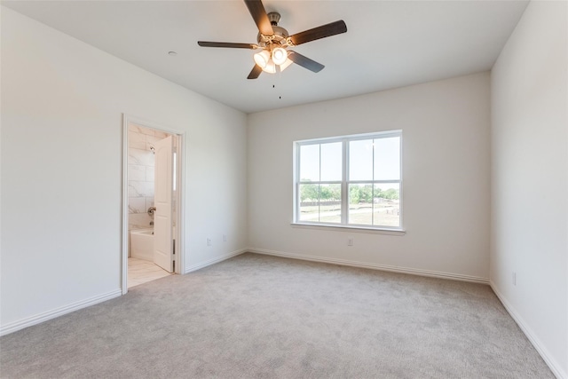 spare room with light carpet and ceiling fan