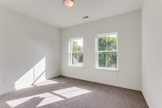 unfurnished room with light carpet