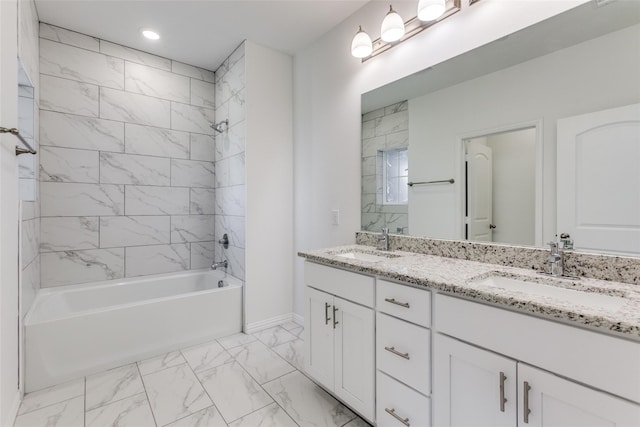 bathroom featuring tiled shower / bath combo and vanity