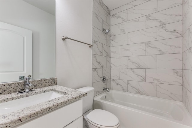 full bathroom featuring tiled shower / bath combo, vanity, and toilet