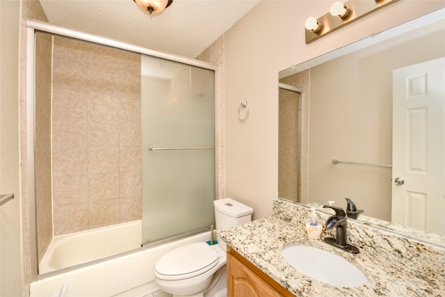 full bathroom with vanity, enclosed tub / shower combo, a textured ceiling, and toilet