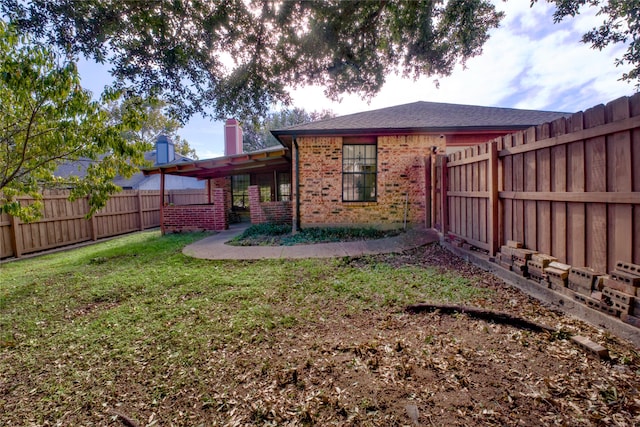 rear view of house with a lawn