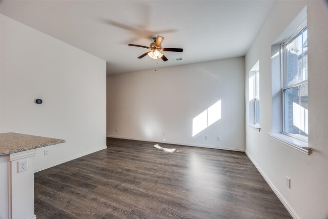 unfurnished living room with ceiling fan and dark hardwood / wood-style floors