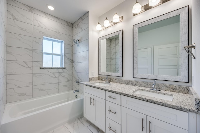 bathroom featuring vanity and tiled shower / bath