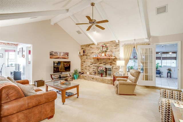 carpeted living room with ceiling fan, beam ceiling, high vaulted ceiling, and a brick fireplace