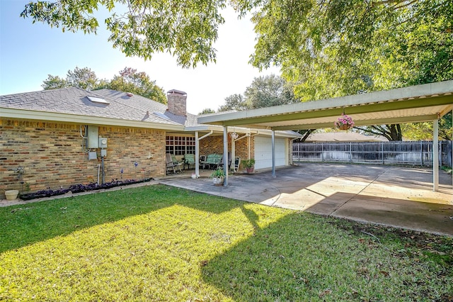 back of house with a yard and a patio