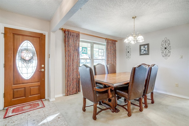 carpeted dining space featuring a textured ceiling and a notable chandelier